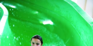 two children inside a green hydro slide