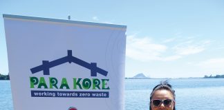 A maori woman standing next ot a sign for Para Kore Marae Incorporated Zero waste initiative