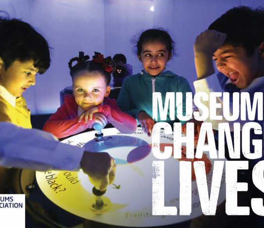 A group of children standing around a table with the caption Museums change lives