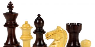 a row of assorted wooden chess pieces