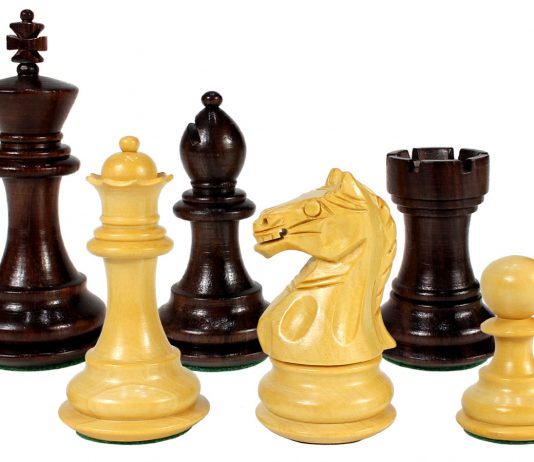 a row of assorted wooden chess pieces