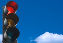 a picture of a traffic light framed by blue sky