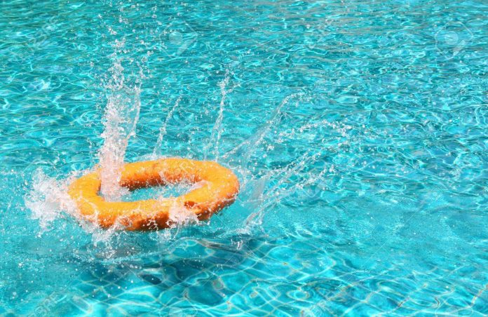 a orange life ring floating in a swimming pool