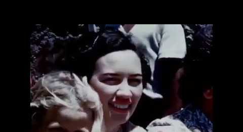 a close up shot of a woman in a crowd circa 1950's or 1960's