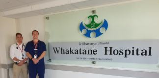 two hospital staff standing next to a whakatane hospital sign