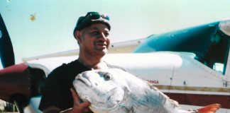 picture of a man holding a large fish