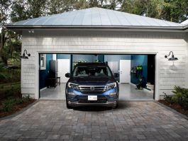 A photograph of a blue Ute parked in an open garage