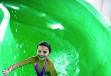 two children inside a green hydro slide