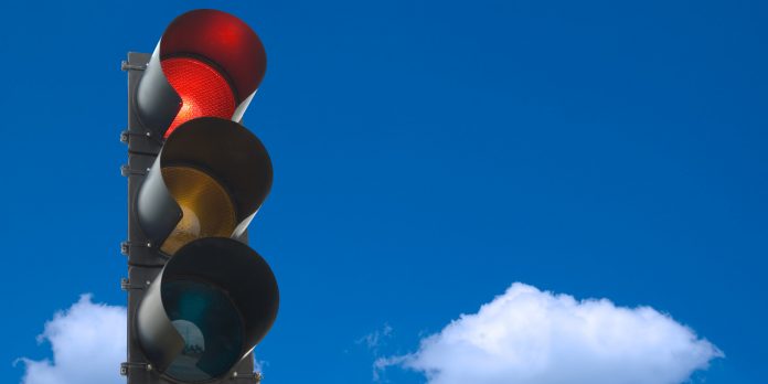 a picture of a traffic light framed by blue sky