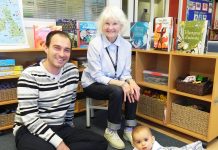 Michael Wenzel (left) with his 7-month-old son Lucas (right) and volunteer Doreen Birchfield (seated centre).