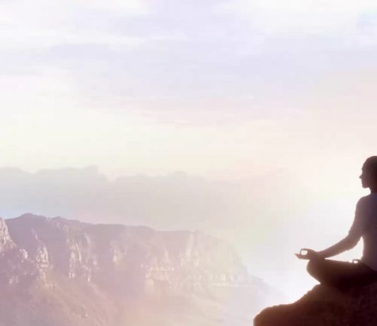 picture of a woman sitting on a rock meditating