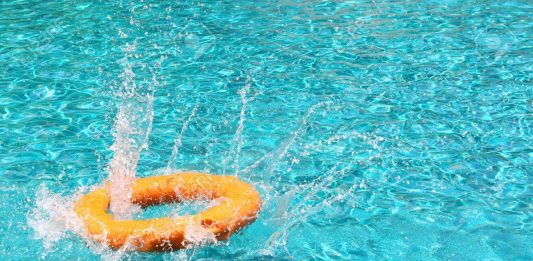 a orange life ring floating in a swimming pool