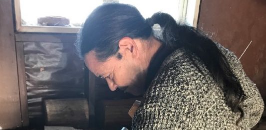 Robert Turner working on a carved piece