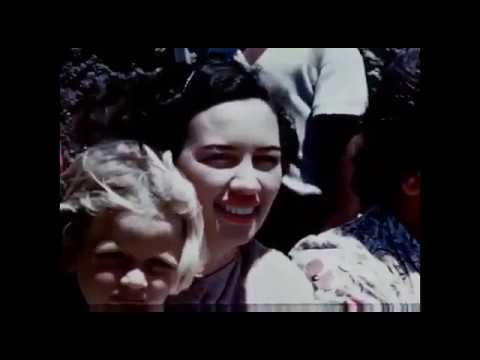 a close up shot of a woman in a crowd circa 1950's or 1960's