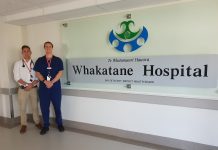 two hospital staff standing next to a whakatane hospital sign