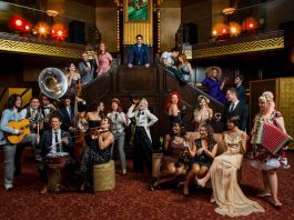 The cast of postmodern jukebox on a flight of stairs