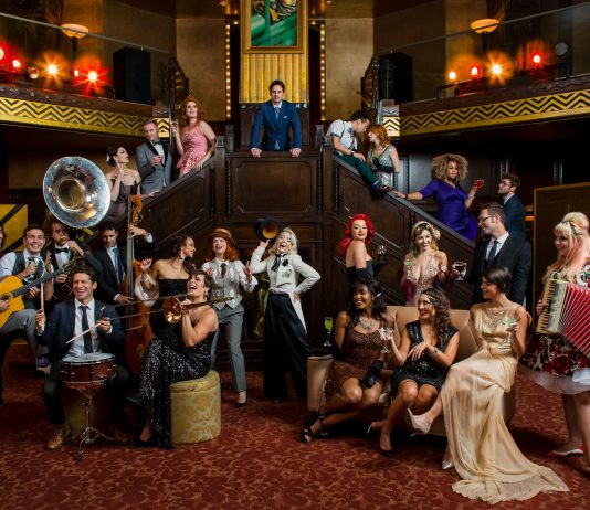 The cast of postmodern jukebox on a flight of stairs