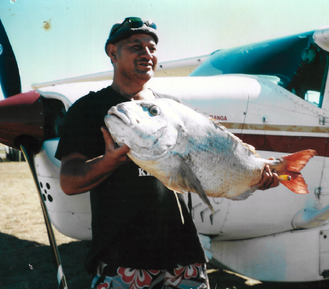 picture of a man holding a large fish